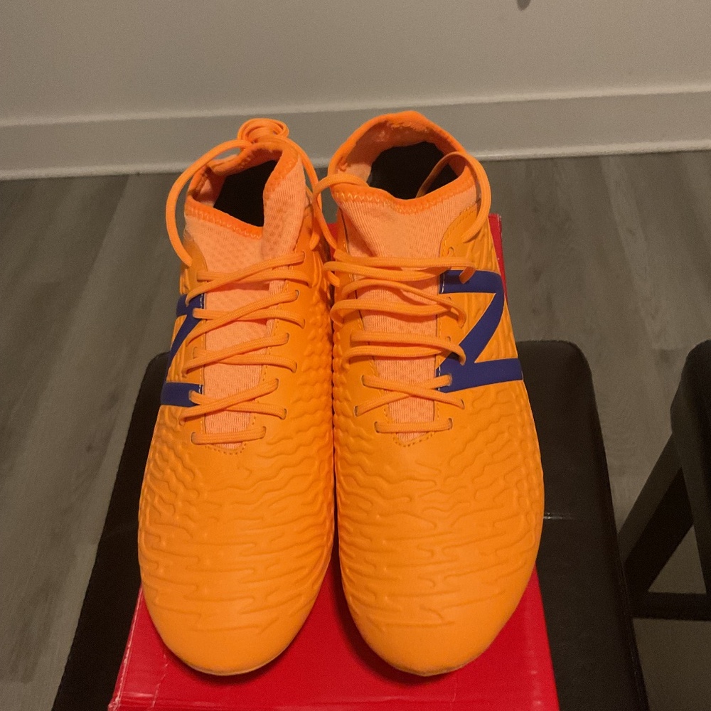New Balance Orange Athletic Soccer Cleats with Blue Accents